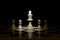 chess pieces on chessboard on black background.