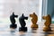 Chess pieces knights facing each other for a standoff on chessboard with blue background. Chess knights confronting each