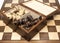 Chess pieces in open storage box on chess board