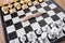 Chess pieces placed on the chessboard and the dollar coin in the middle