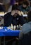 Chess players during gameplay at a local tournament vertical