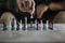Chess players hand rearranges a chess piece