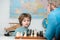 Chess school. Games and activities for children. Family concept. Little boy with chess.