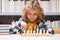 Chess, success and winning. Clever concentrated and thinking kid playing chess. Kids brain development and logic game.