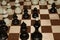 Chessboard with black chessmen for hobby backdrop