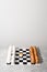 Chessboard with figures of white and brown eggs on a gray background. Creative Idea Easter and chess