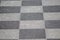 Chessboard pattern in waiting area on sidewalk pavement shows black and white checkerboard texture in rhombuses geometric shapes