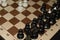 Chessboard under black chessmen as a skill backdrop