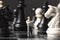 Chessman and chess figures on game board. Playing chess with miniature doll macro photo.