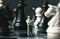 Chessman and chess figures on game board. Playing chess with miniature doll macro photo.