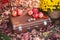 Chest in autumn leaves, chrysanthemums in flowerpots, apples and nuts