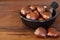 Chestnut in black bowl on wooden table