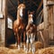 Chestnut brown mother and foal stand in hay filled stables