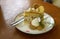 Chestnut with caramel salted cake serving with cookies on flower pattern plate