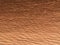 Chestnut color background. Abstract rippled and wavy surface in warm earth color tone