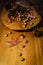 Chestnuts and hazelnuts on a wooden bowl over a wood table