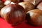 Chestnuts macro over red studio background