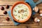 Chestnuts and mushroom soup in ceramic bowl