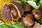 Chestnuts with raindrops on a background of leaves