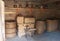 Chests, barrels and a shelf with dishes in the ancient peasant hut