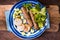 Chevanchichi with lettuce and daikon on a blue plate