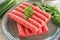 Chevapchichi is a national Balkan dish. Close up a row of fresh raw beef kebabs on a plate