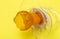 A chewed baby pacifier on a yellow background. Concept of teething in children, close-up.