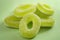 Chewy sweets and apple flavoured gummy candy concept with close up on sweet and sour green rings covered in granulated sugar