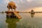 Chhatris and shrines of hindu Gods and goddesses at Gadisar lake, Jaisalmer, Rajasthan, India with reflection on water. Indo-
