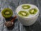 Chia and kiwi seed pudding on a dark rustic table.