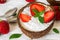 Chia pudding with fresh strawberry and mint in coconut bowl with spoons. healthy breakfast