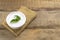 Chia pudding with mint leaves in a white bowl on a wooden background. Rustic style.