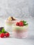 Chia seed pudding with three flavors, cocoa, matcha and strawberry with yoghurt, chocolate and mint leaves, vertical orientation