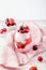 Chia seeds, cherry and strawberry layered pudding in glasses on table