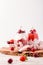 Chia seeds, cherry and strawberry layered pudding in glasses on table