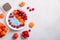 Chia seeds pudding bowl with apricot, raspberry on concrete background. Mousse with chia seeds, berries and fruits for