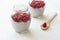 Chia seeds pudding with coconut milk and raspberry in glass jars