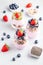 Chia seeds pudding with granola, blueberry and strawberry in glasses. Yogurt with chia seeds, berries, kiwi and muesli for healthy