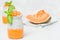 Chia seeds pudding with pumpkin puree in beautiful glasses with green mint leaves and cut fresh ripe orange vegetable.