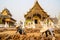 Chiang Mai/Thailand - March 16, 2019: Worker is paving the walkway with cobblestones in a Buddhist temple.