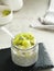 Chiaseed served in a glass jar topped with yogurt and kiwi fruit.