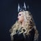 Chic Gothic Queen from a dark fairy tale. Young blonde woman in black with steel crown on her head