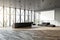 Chic office lobby with expansive windows, herringbone floor, and black sofas.