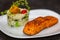 Chic plate of grilled salmon with broccoli rice garnished with fine herbs.