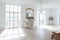 Chic white huge spacious hall with a minimum of expensive antique furniture. Baroque interior design with ornament on the walls