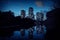 Chicago high-rise buildings by the Lincoln Park Pond. Water reflections and a dramatic sunset sky. .