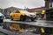 Chicago, IL - November 30th, 2019: A yellow taxi cab drives past a large puddle forming at the intersection of Clark Street and