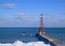 Chicago lighthouse juts out into a frozen Lake Michigan on a freezing winter day in January.