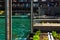 Chicago River with measurement poles, floating ecosystem garden beds, and fishing piers along the riverwalk.