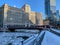 Chicago winter featuring snow covered riverwalk, ice chunks on river and commuters bundled up